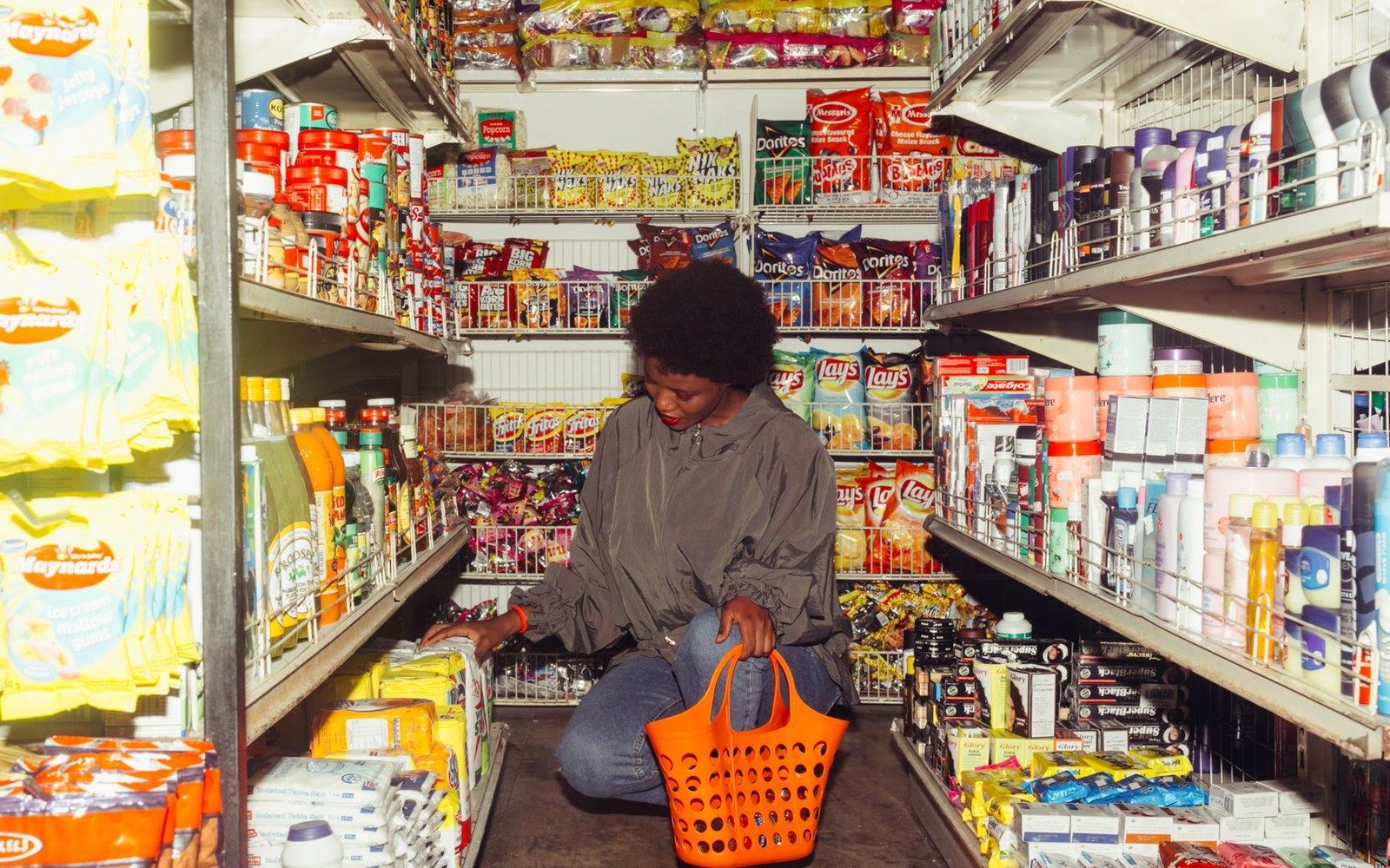 Shoppers entering a large store, the floor inside the doors left open and unstocked