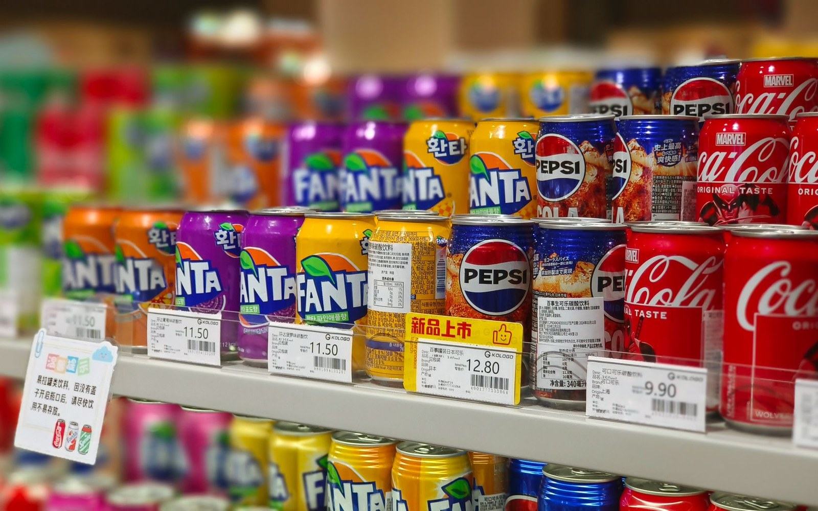 A shelf edge of printed price labels, close